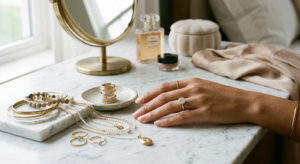 A high-end editorial shot featuring an elegant woman’s hand delicately wearing a timeless diamond ri